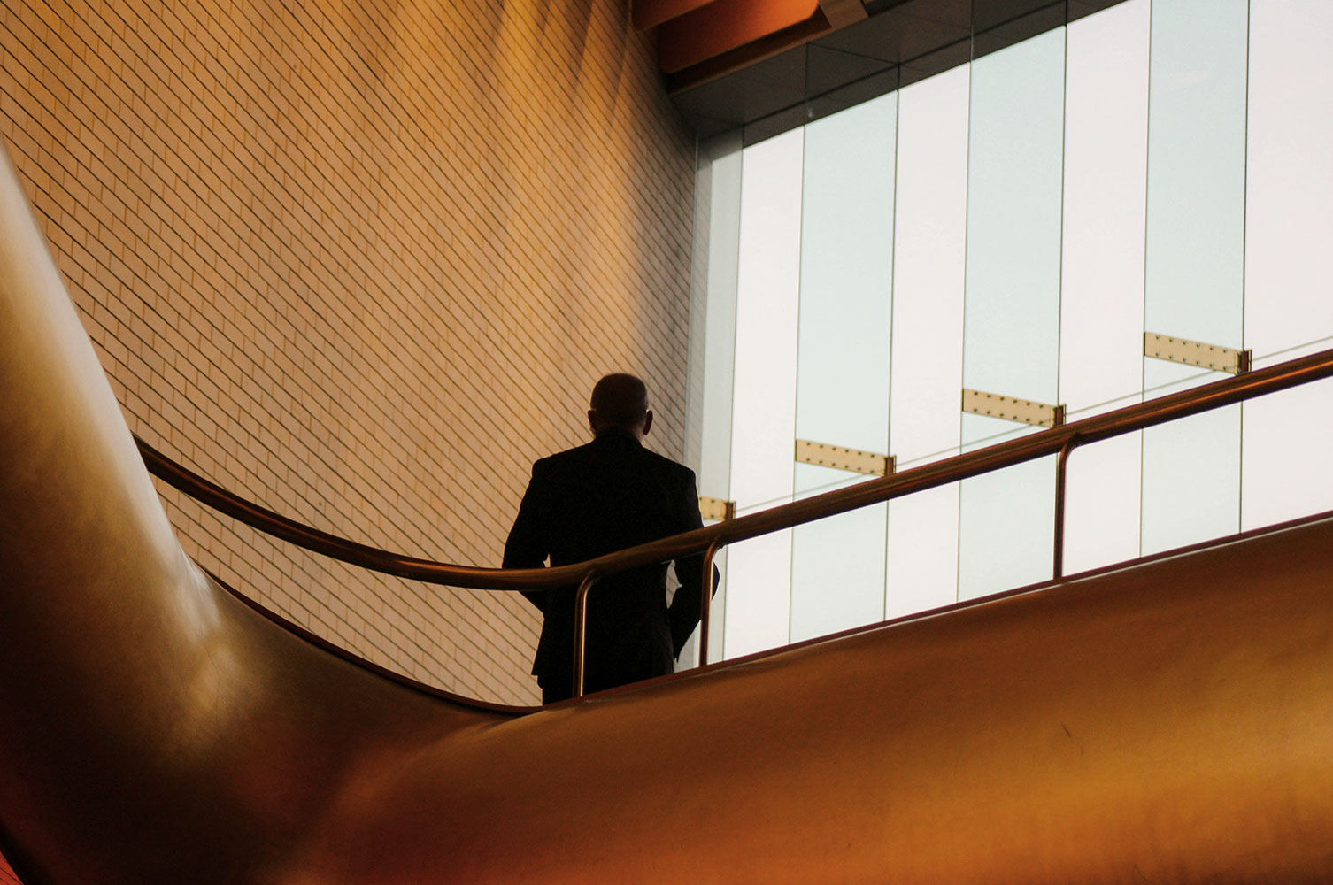 Person standing in an office on a balcony